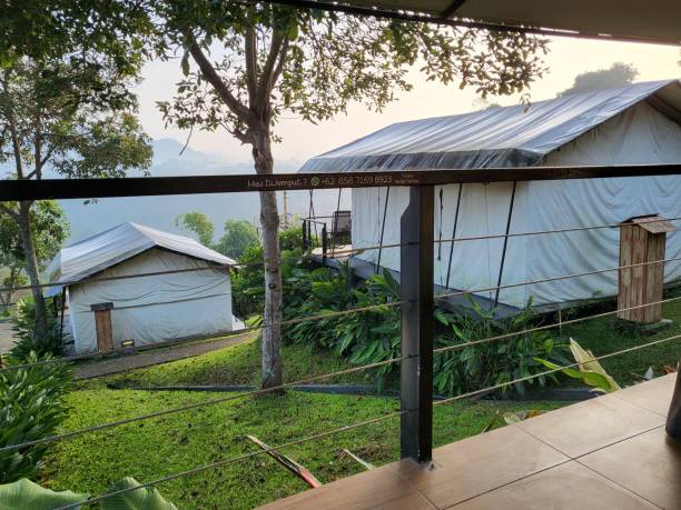 istock Two large white tents with a mountain view in the background 1362632298