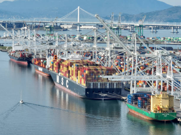 Aerial View of Port of Oakland Vessels and cranes at the Port of Oakland container terminal in Oakland, California. commercial dock stock pictures, royalty-free photos & images