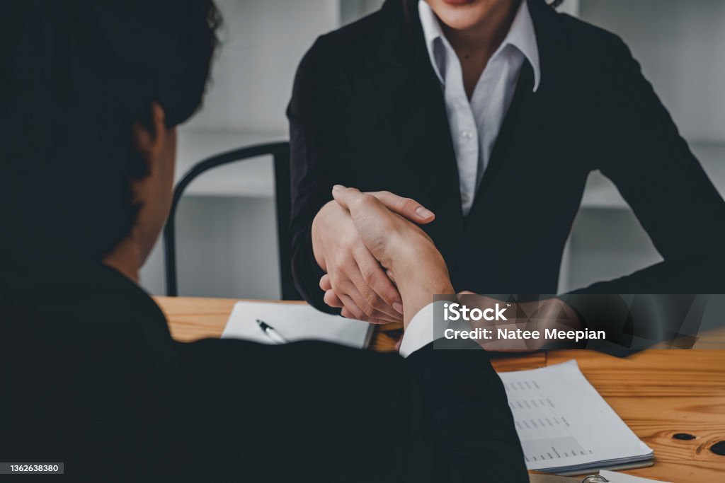 Close up business people shaking hands, finishing up meeting. success, dealing, greeting and partner concept. Close up business people shaking hands, finishing up meeting, success, dealing, greeting and partner concept Selling Stock Photo
