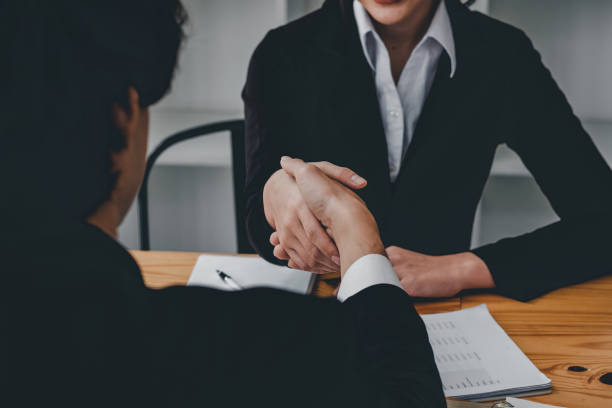 close up business people shaking hands, finishing up meeting. success, dealing, greeting and partner concept. - lawyer young adult suit expressing positivity imagens e fotografias de stock