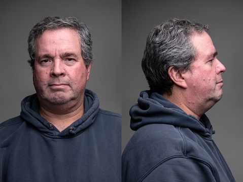 Spanish mature man front and profile mugshots on gray background