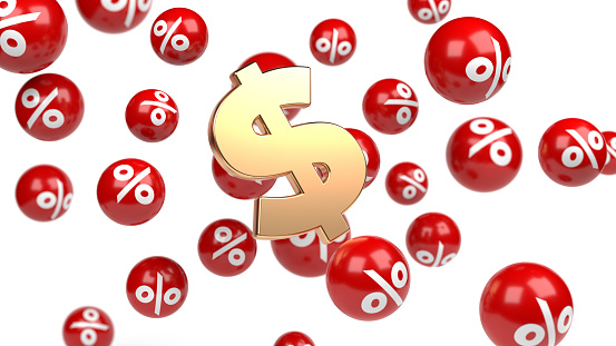 The gold-colored dollar sign and falling sphere-shaped percentage symbols. On white-colored background. Horizontal composition with copy space.focused image