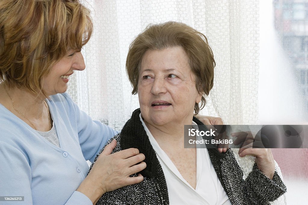 Love Mature daughter embracing her mother and they and looking at each other. 50-54 Years Stock Photo