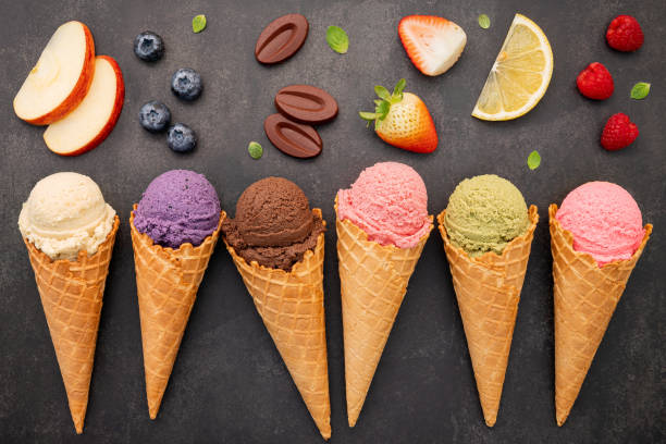 istock Flat lay ice cream cones collection on dark stone background . Blank crispy ice cream cone with copy space for sweets menu design. 1362655745