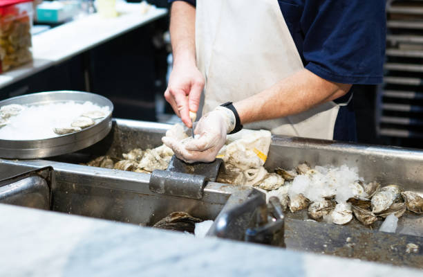 istock Opening fresh oysters at restaurant 1362655861