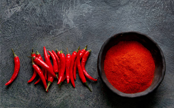 istock Red chili or chilli cayenne pepper on dark background. 1362655915