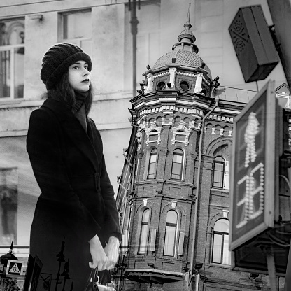 Woman wearing vintage hat with wooden door background.