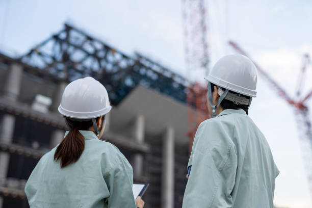 Female contractors working at construction site stock photo