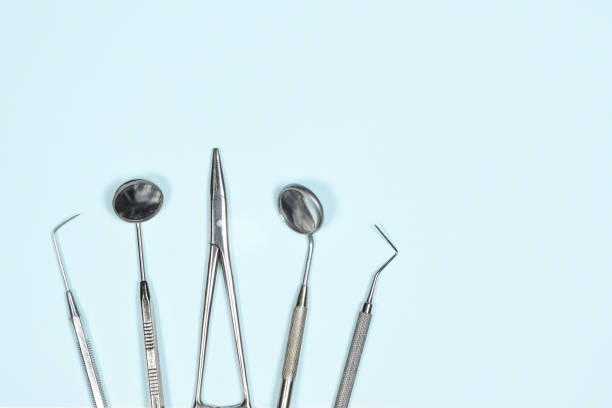 istock Medical dental instruments on light blue background with copy space. Flat lay close up top view on dental equipment. dental mirrors, probes, forcepts 1362668163