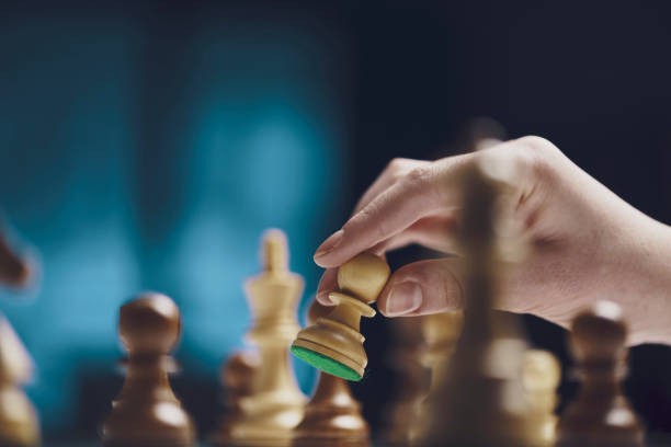 istock Chess game tournament: the player is moving a pawn 1362670204