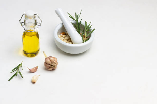 istock Olive oil in bottle. Nuts in mortar. 1362671513
