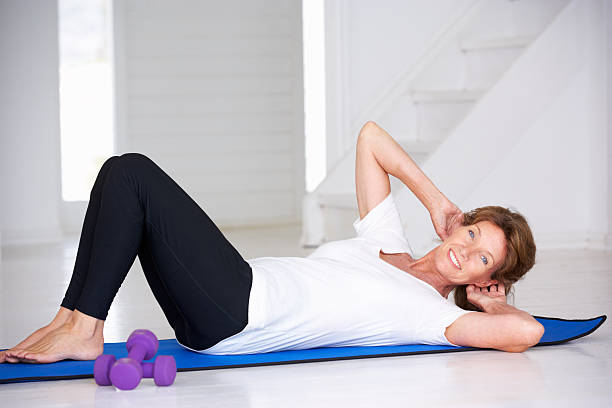 istock Senior woman doing curl-ups 136267216