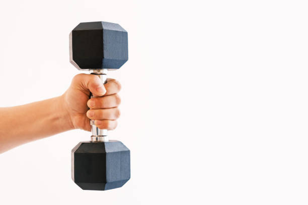 Male hand holding an iron dumbbell on white background, copy space.