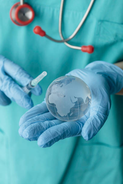 istock Doctor Holding Globe with Vaccine 1362676897