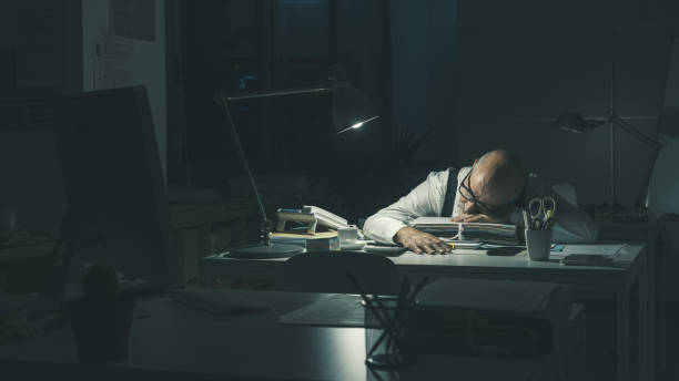 istock Stressed businessman sleeping at desk 1362677036