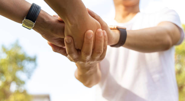 istock Selective focus of Man hand and holding hands together for comfort and support work together, Actually help as insurance team,respect and trust concept 1362680099