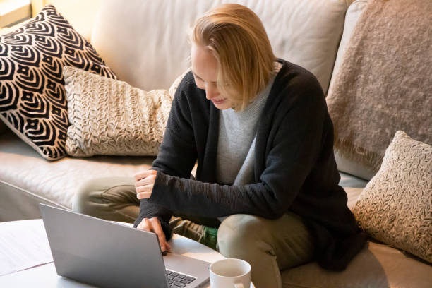 istock Relaxed female on sofa with laptop 1362683061