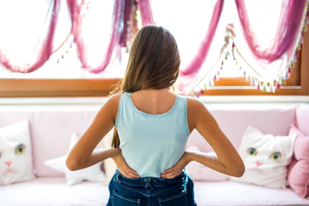 Little girls with backache, pain in the human body stock photo