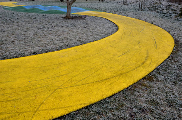 Skateboard, skating park for roller skating with a concrete cement surface painted blue and yellow. turns and training waves with obstacles. Freestyle cycling, children Protective clothing, first bike