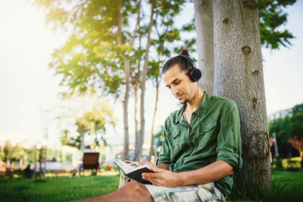 Photo of Young man learning in the park
