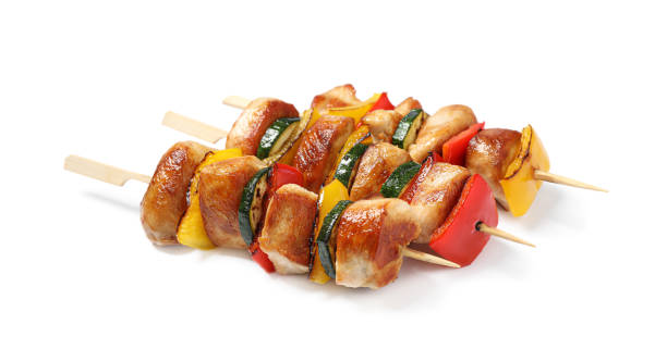 Delicious chicken shish kebabs with vegetables on white background Delicious chicken shish kebabs with vegetables on white background shish kebab stock pictures, royalty-free photos & images