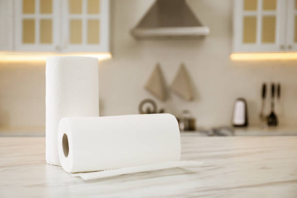 Rolls of paper towels on white table in kitchen