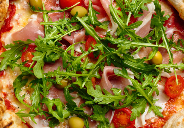 istock Tasty pizza with meat and arugula as background, top view 1362687562
