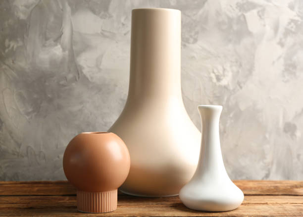 istock Stylish empty ceramic vases on wooden table against grey background 1362687927