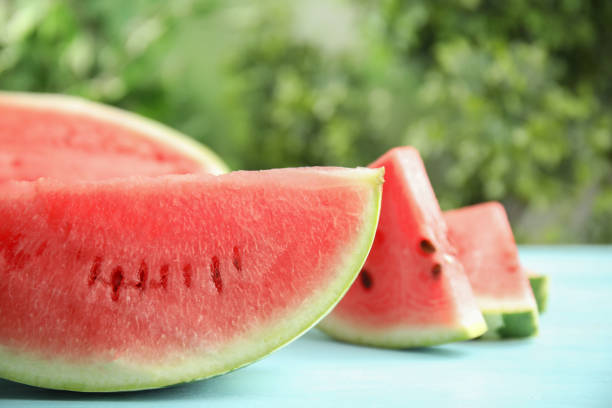 istock Tasty ripe cut watermelon on light blue wooden table 1362690470