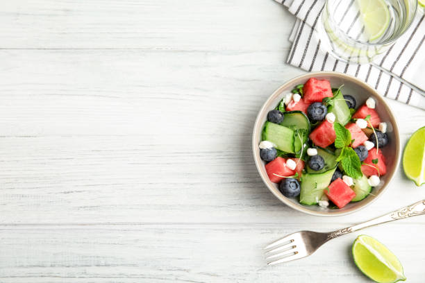 istock Delicious salad with watermelon served on white wooden table, flat lay. Space for text 1362690756