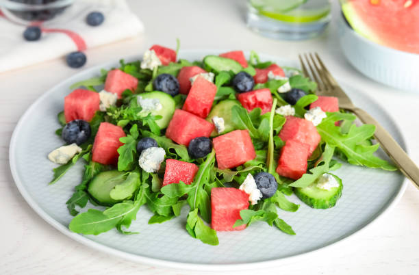 istock Delicious salad with watermelon served on white table, closeup 1362691948