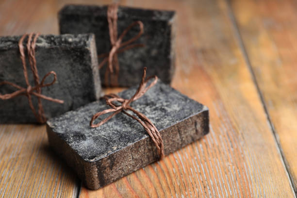 Natural tar soap on wooden table, closeup