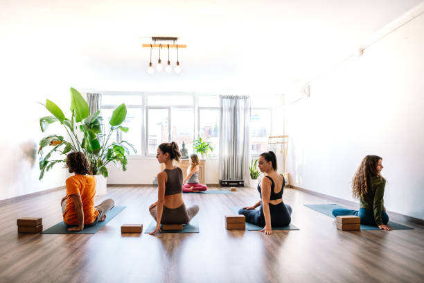 istock People doing Seated Twist pose during yoga lesson 1362692068