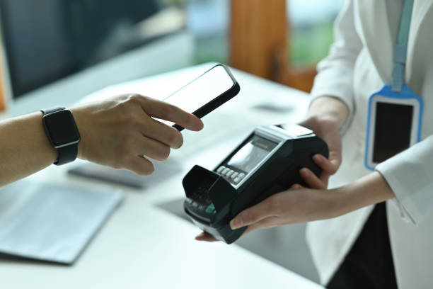 istock Cropped image of customer's hand holding a smartphone for doing a payment by using NFC technology. 1362695745