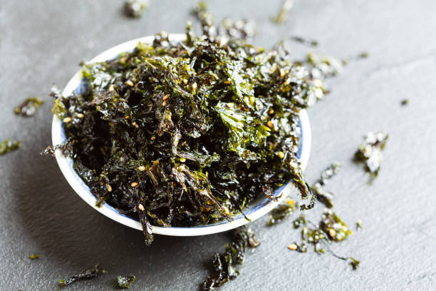 Roasted salted laver Snack in a bowl crispy korean Roasted salted laver Snack in a bowl nori edible seaweed sheet stock pictures, royalty-free photos & images
