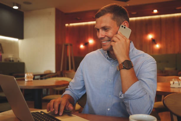 istock Happy man talking on smartphone in cafe 1362699693