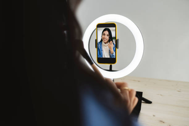 istock woman recording while putting on makeup 1362702772