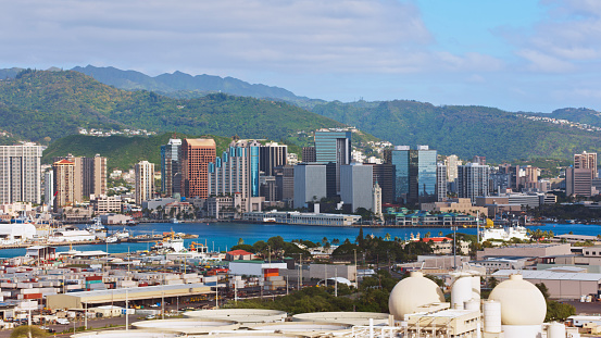 Aerial view of downtown Honolulu on Oahu island with mountains in background, Hawaii Islands, USA.