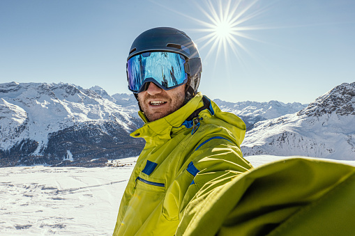 Young man takes a selfie on wile skiing in the Alps, Weekend activities, people getting away from it all