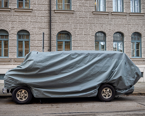 Small bus under a tarpaulin in the German city Munich, which is the capital city in Bavaria