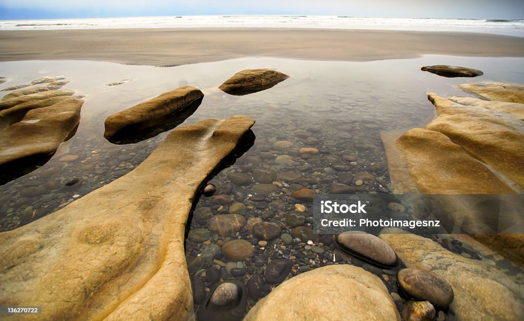 West Coast seascape, New Zealand Reflections of rocks in seascape on West Coast, South Island, New Zealand Cloud - Sky Stock Photo