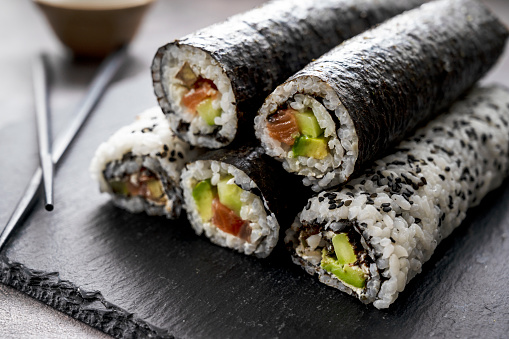 Sushi rolls. Homemade rolls with salmon, avocado and cucumber