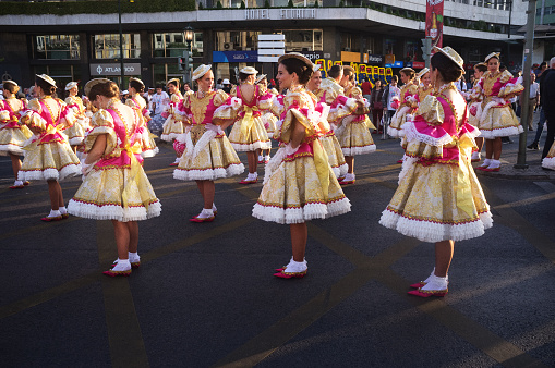 Lisbon, Portugal - June 12, 2018: Women dressed in traditional folklore costumes, prepare to parade in Lisbon downtown during this city celebrations of the Popular Saints.