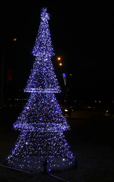 istock Artificial Christmas tree in garlands at night. 1362709495