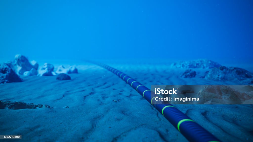 Underwater Fiber Optic Cable On Ocean Floor Underwater fiber-optic cable on ocean floor. Cable Stock Photo