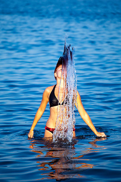 istock Young woman having fun in sea 136271097