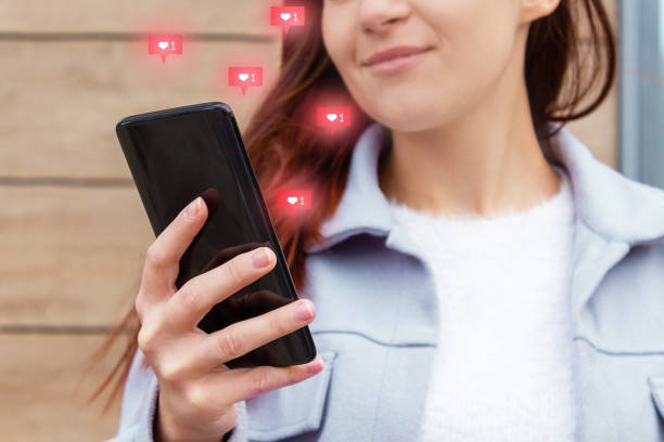 istock Likes from phone screen. Attractive young woman 1362713534