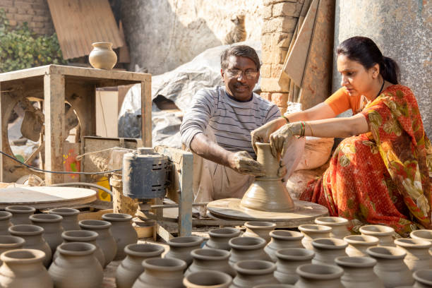 istock Father with daughter making clay pot on spinning wheel 1362713554