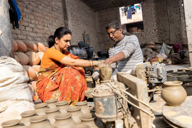 istock Father with daughter making clay pot on spinning wheel 1362713557