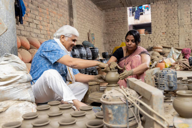 istock Father with daughter making clay pot on spinning wheel 1362713621